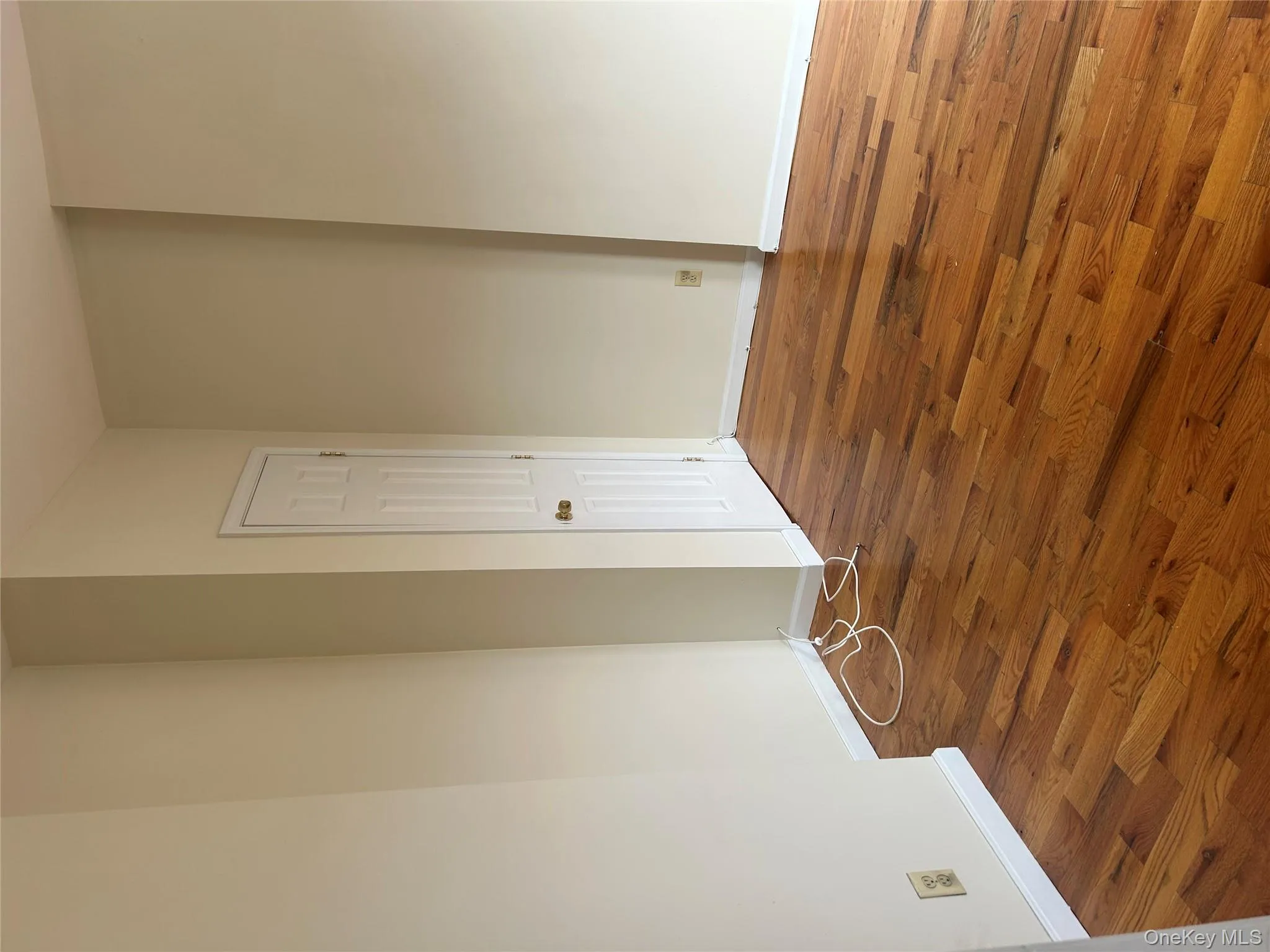 Spare room with baseboards and wood finished floors Spare room with baseboards and wood finished floors
