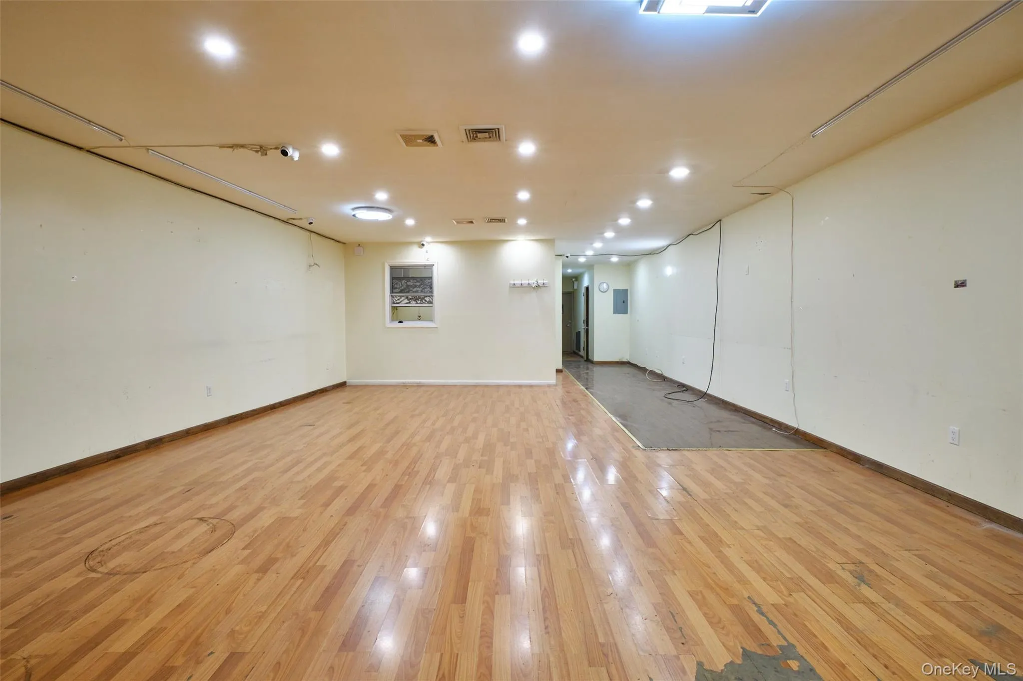 Empty room with light wood-type flooring and recessed lighting Empty room with light wood-type flooring and recessed lighting