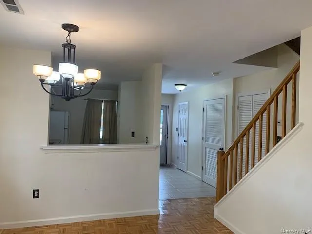 Kitchen with freestanding refrigerator, a chandelier, and decorative light fixtures Kitchen with freestanding refrigerator, a chandelier, and decorative light fixtures