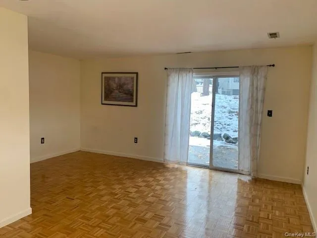 Unfurnished room with baseboards Unfurnished room with baseboards