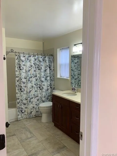 Full bathroom with vanity and shower / bath combination with curtain Full bathroom with vanity and shower / bath combination with curtain