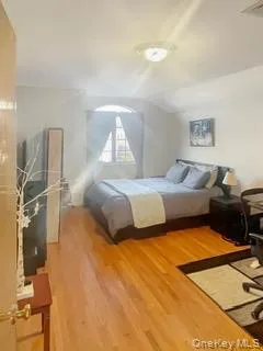 Bedroom with light wood-type flooring and vaulted ceiling Bedroom with light wood-type flooring and vaulted ceiling