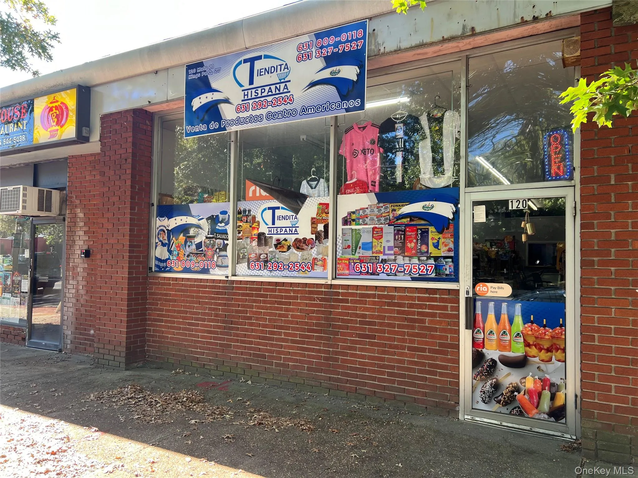 View of building exterior featuring a wall mounted AC View of building exterior featuring a wall mounted AC
