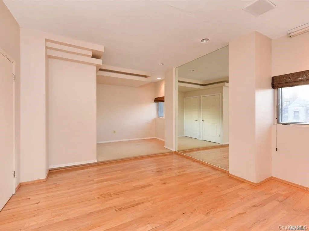 Unfurnished room featuring light wood finished floors and recessed lighting Unfurnished room featuring light wood finished floors and recessed lighting