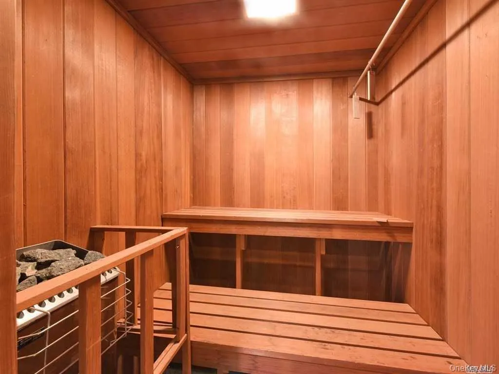 Relaxing sauna / steam room featuring wooden ceiling and wooden walls Relaxing sauna / steam room featuring wooden ceiling and wooden walls