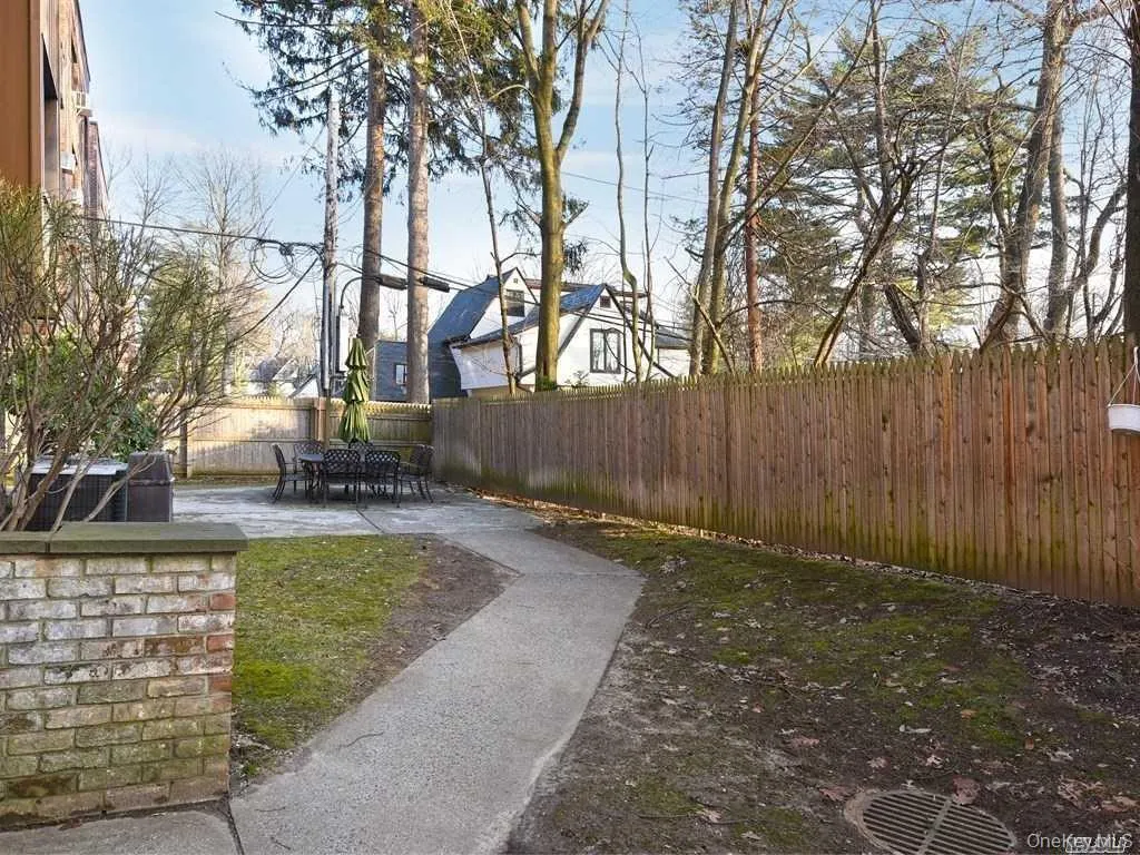 Fenced backyard with a patio area Fenced backyard with a patio area