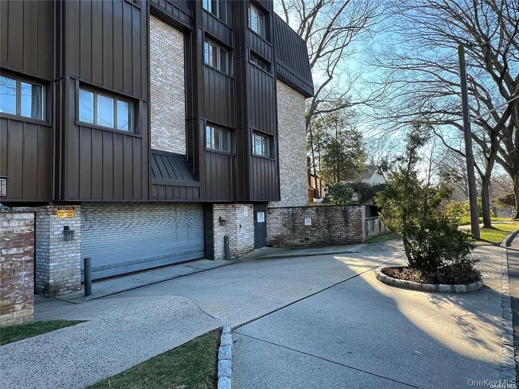 View of home's exterior with board and batten siding and brick siding View of home's exterior with board and batten siding and brick siding
