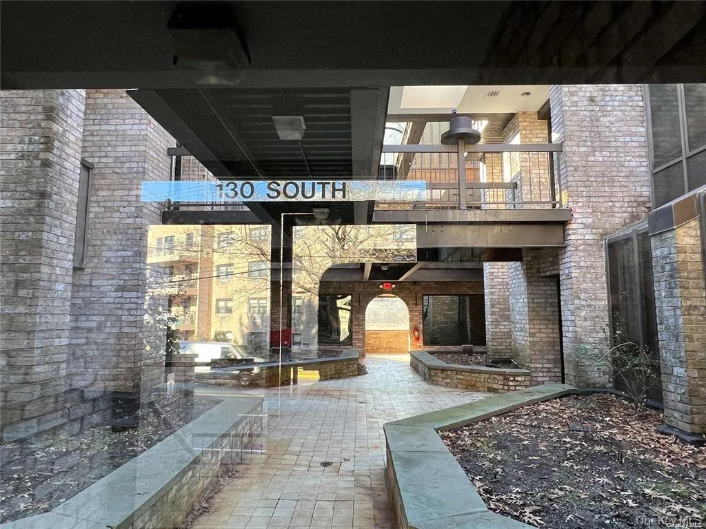 Property entrance with brick siding and a patio area Property entrance with brick siding and a patio area