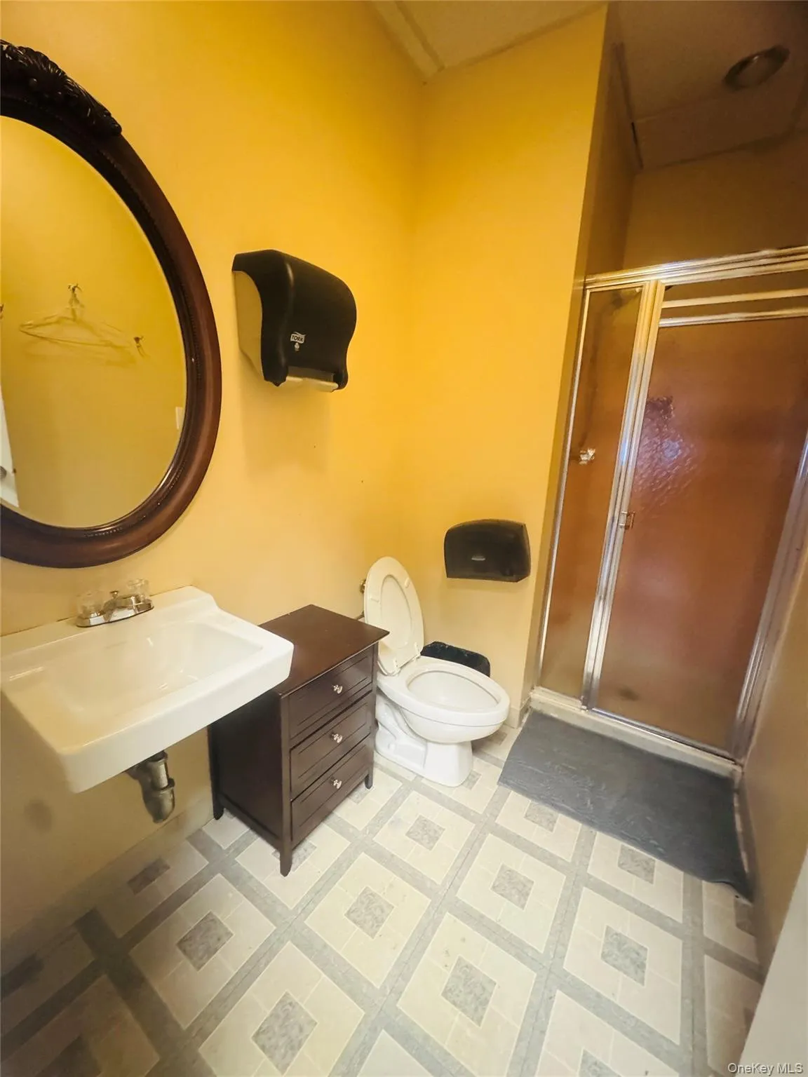 Full bath featuring a sink and a shower stall Full bath featuring a sink and a shower stall