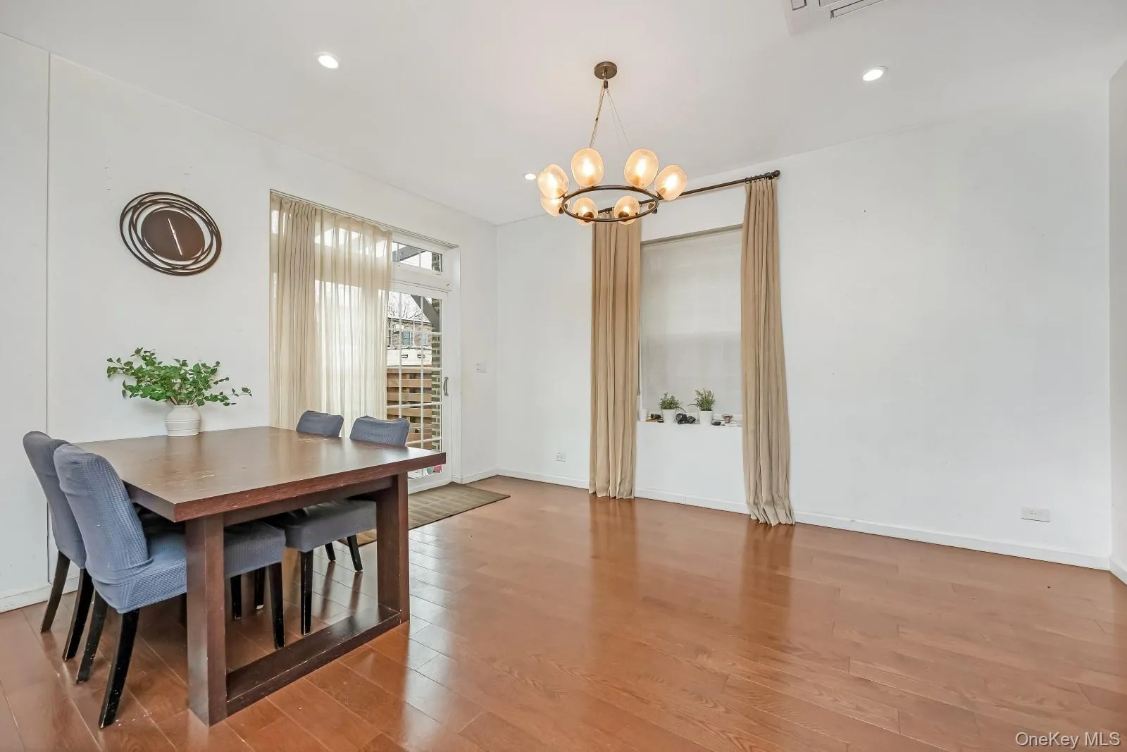 Dining area featuring light wood finished floors, recessed lighting, and a chandelier Dining area featuring light wood finished floors, recessed lighting, and a chandelier