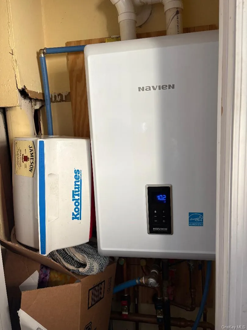 Utility room with tankless water heater Utility room with tankless water heater