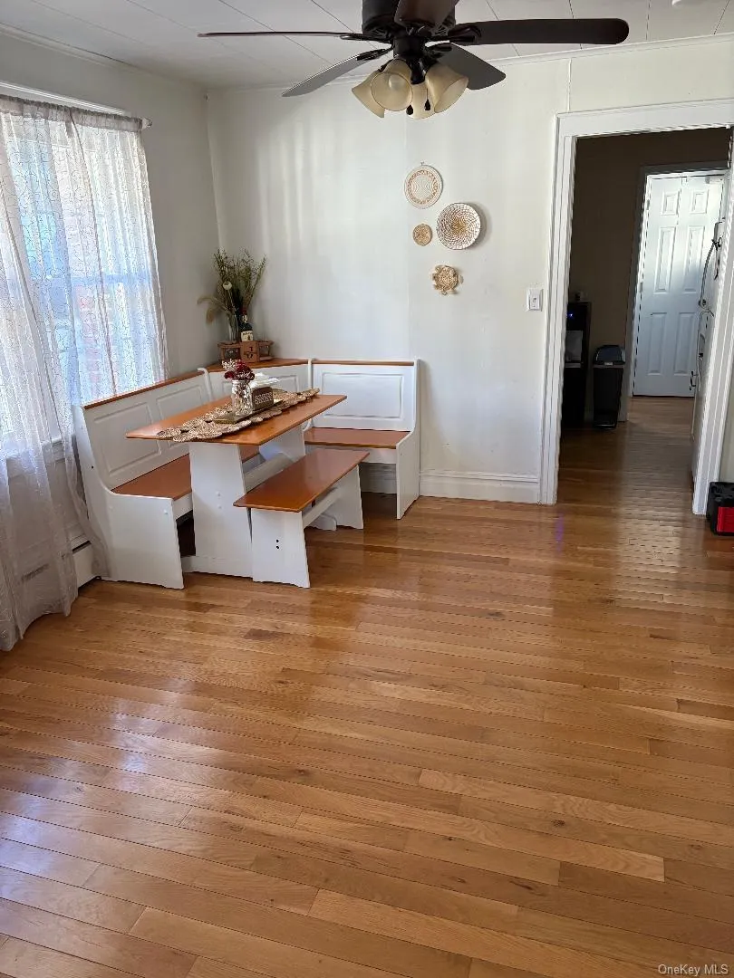Dining space with light wood-type flooring and ceiling fan Dining space with light wood-type flooring and ceiling fan