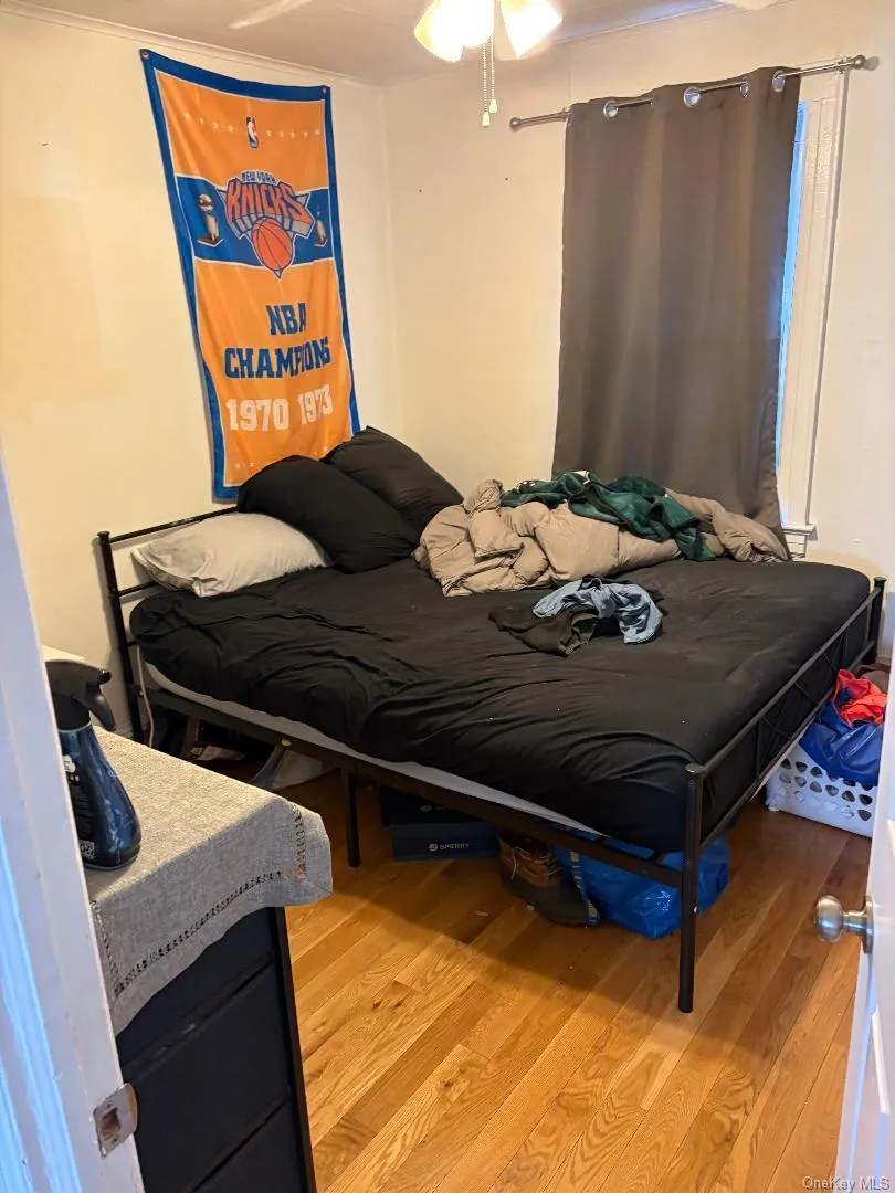 Bedroom featuring light wood-type flooring and crown molding Bedroom featuring light wood-type flooring and crown molding
