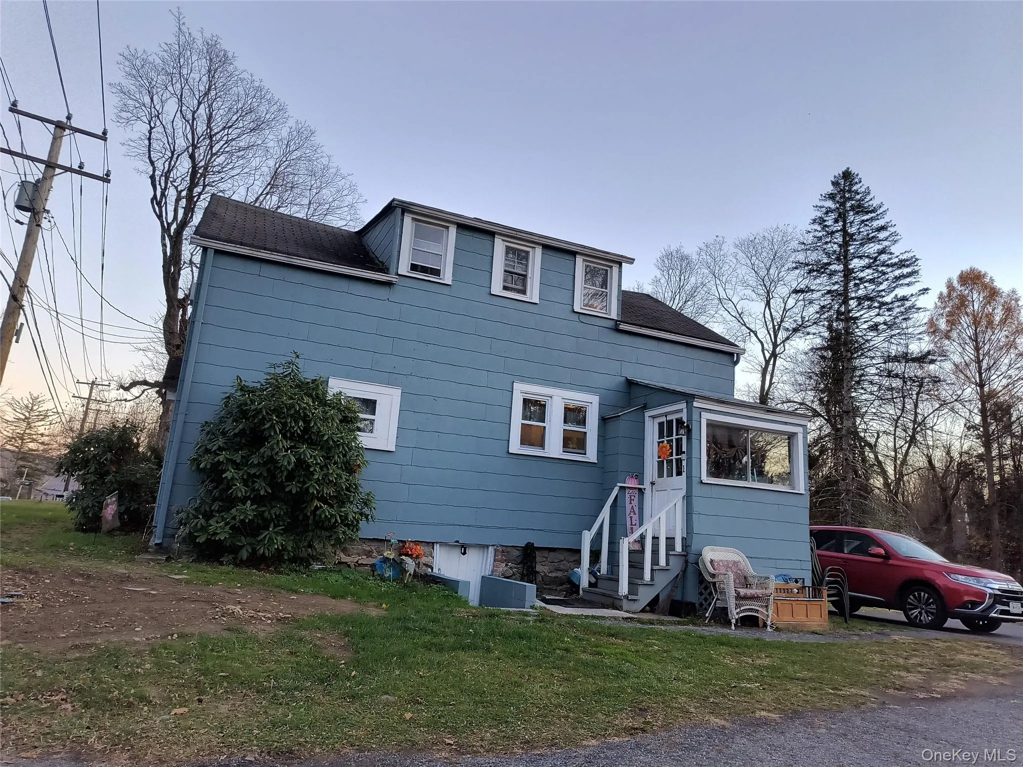 View of front of house featuring a shingled roof, a front lawn, and entry steps View of front of house featuring a shingled roof, a front lawn, and entry steps
