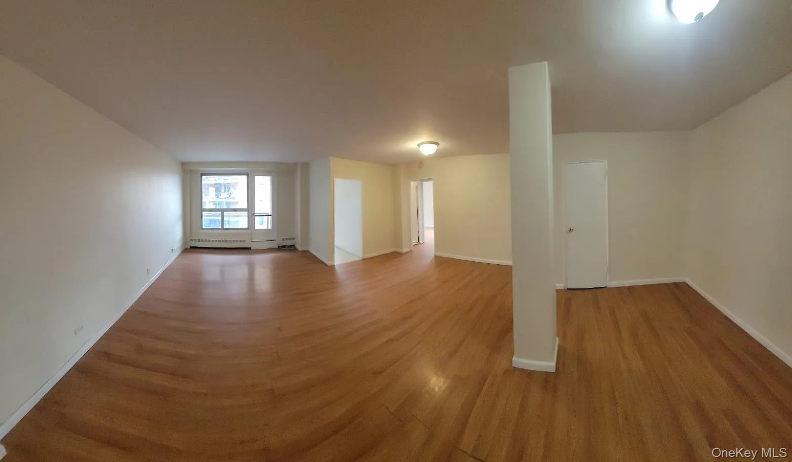 Empty room featuring light wood-type flooring and baseboards Empty room featuring light wood-type flooring and baseboards