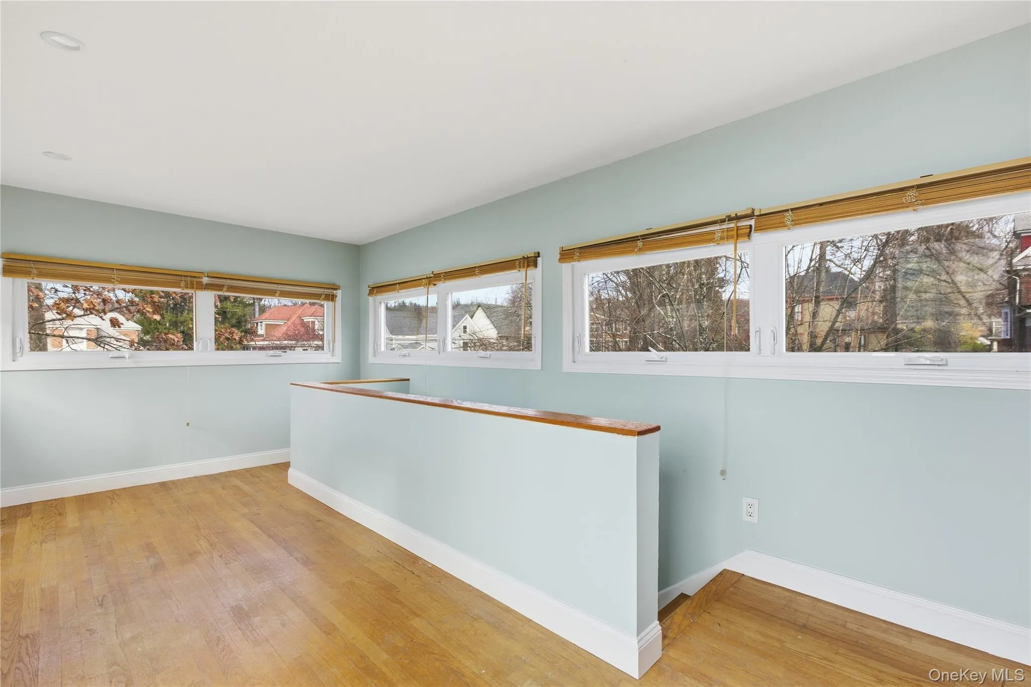 Empty room with baseboards and light wood finished floors Empty room with baseboards and light wood finished floors