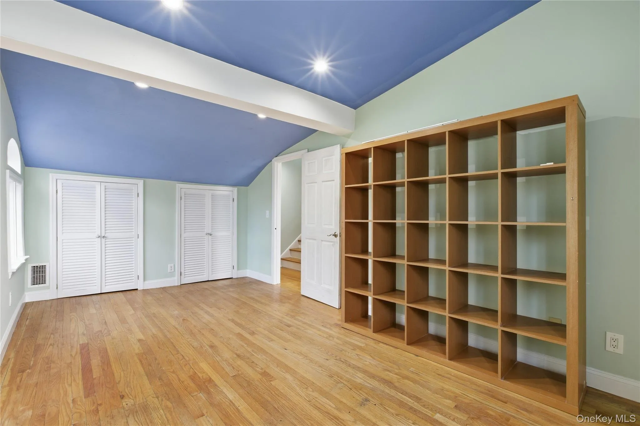 Unfurnished bedroom featuring multiple closets, light wood-type flooring, and recessed lighting Unfurnished bedroom featuring multiple closets, light wood-type flooring, and recessed lighting
