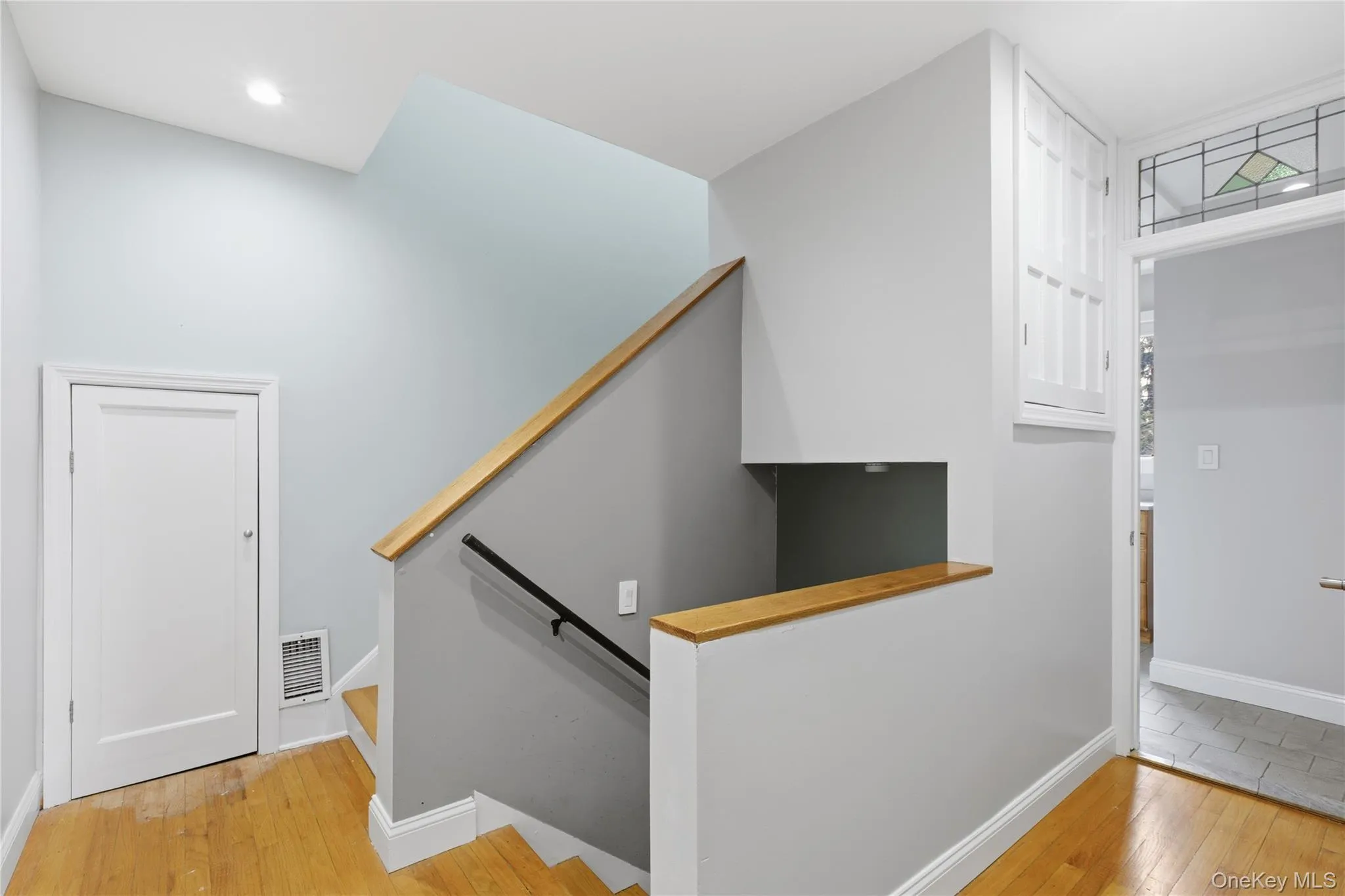 Stairs featuring hardwood / wood-style flooring and baseboards Stairs featuring hardwood / wood-style flooring and baseboards