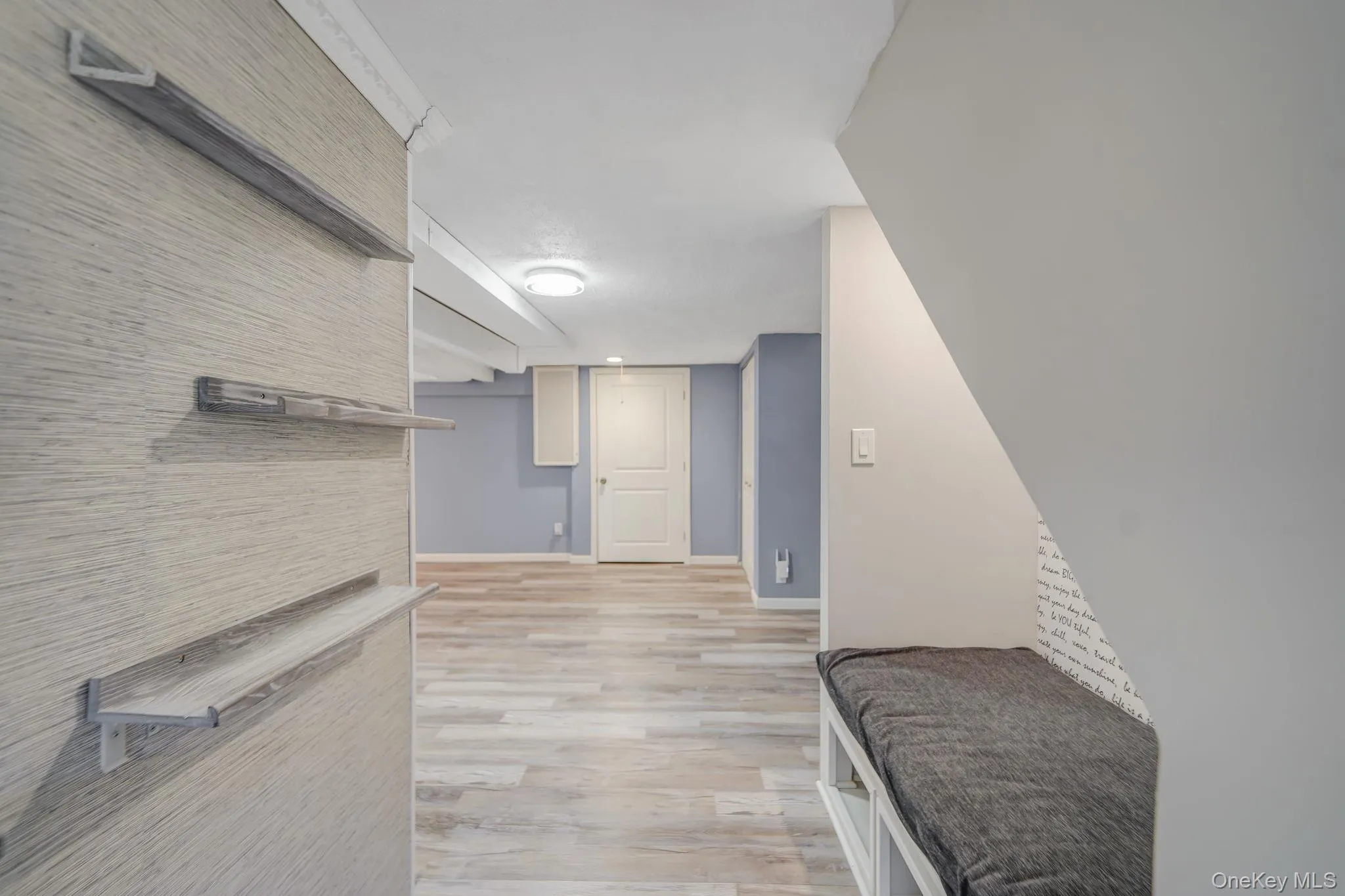 Hallway with light wood-style floors and baseboards Hallway with light wood-style floors and baseboards