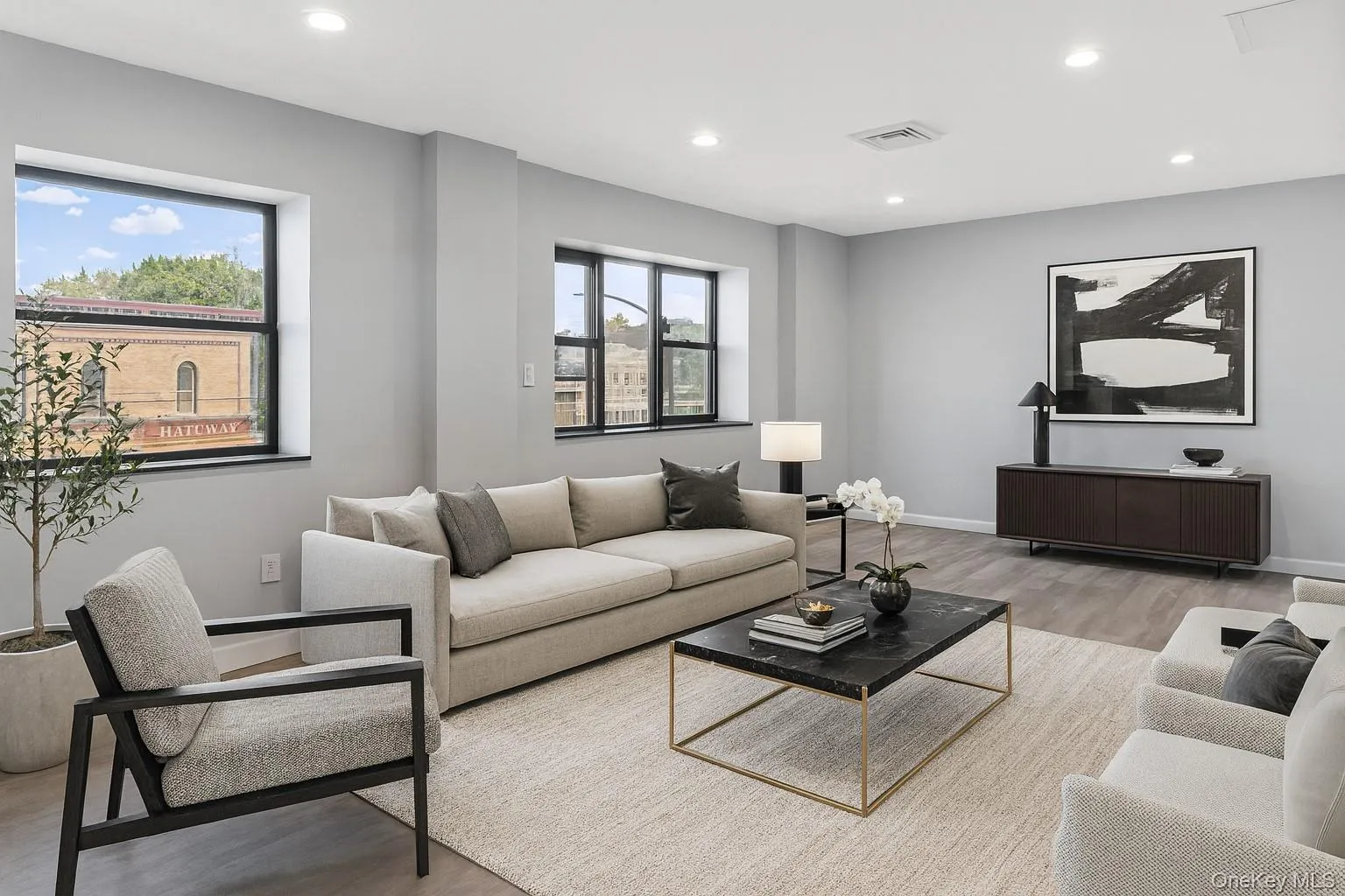 Living area featuring plenty of natural light, light wood finished floors, and recessed lighting Living area featuring plenty of natural light, light wood finished floors, and recessed lighting