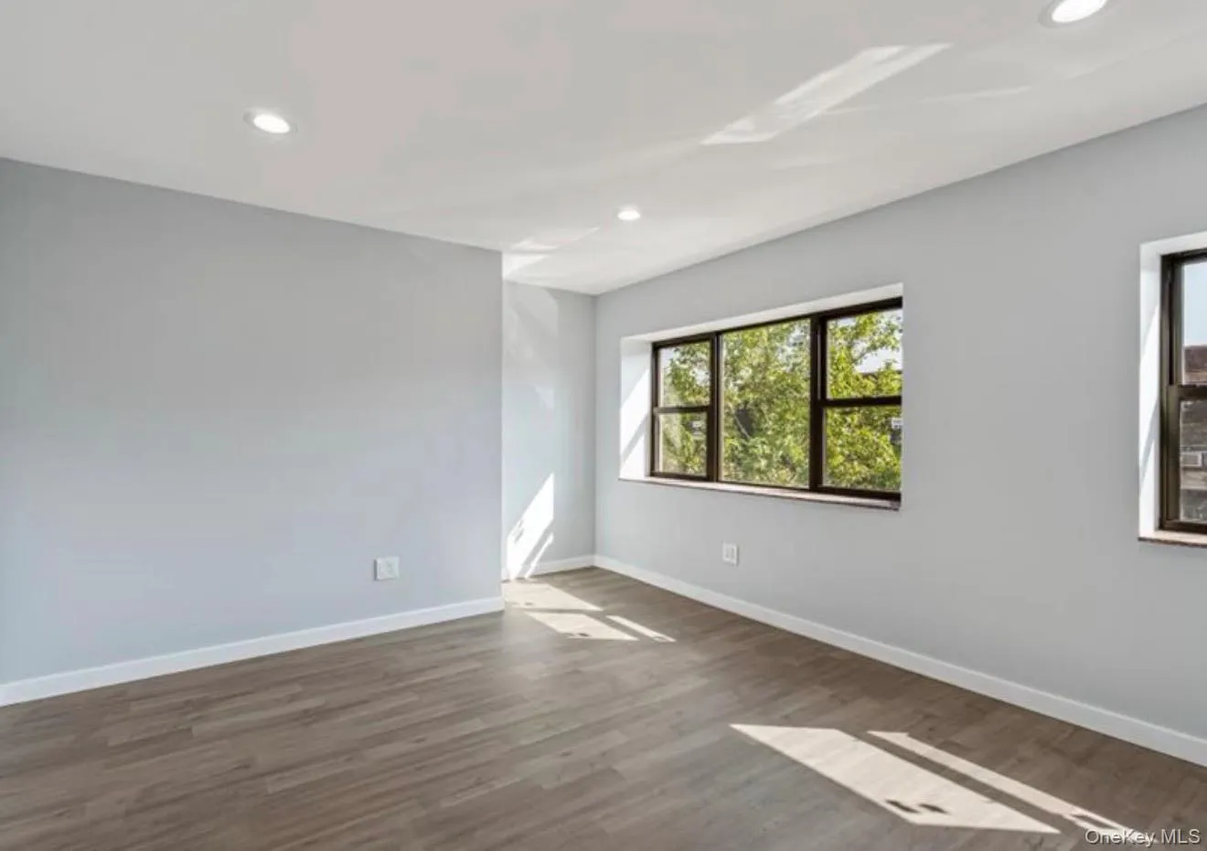 Unfurnished room featuring dark wood finished floors and recessed lighting Unfurnished room featuring dark wood finished floors and recessed lighting