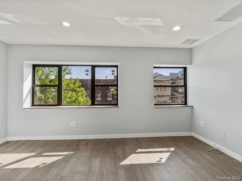 Unfurnished room featuring healthy amount of natural light, light wood-type flooring, and recessed lighting Unfurnished room featuring healthy amount of natural light, light wood-type flooring, and recessed lighting