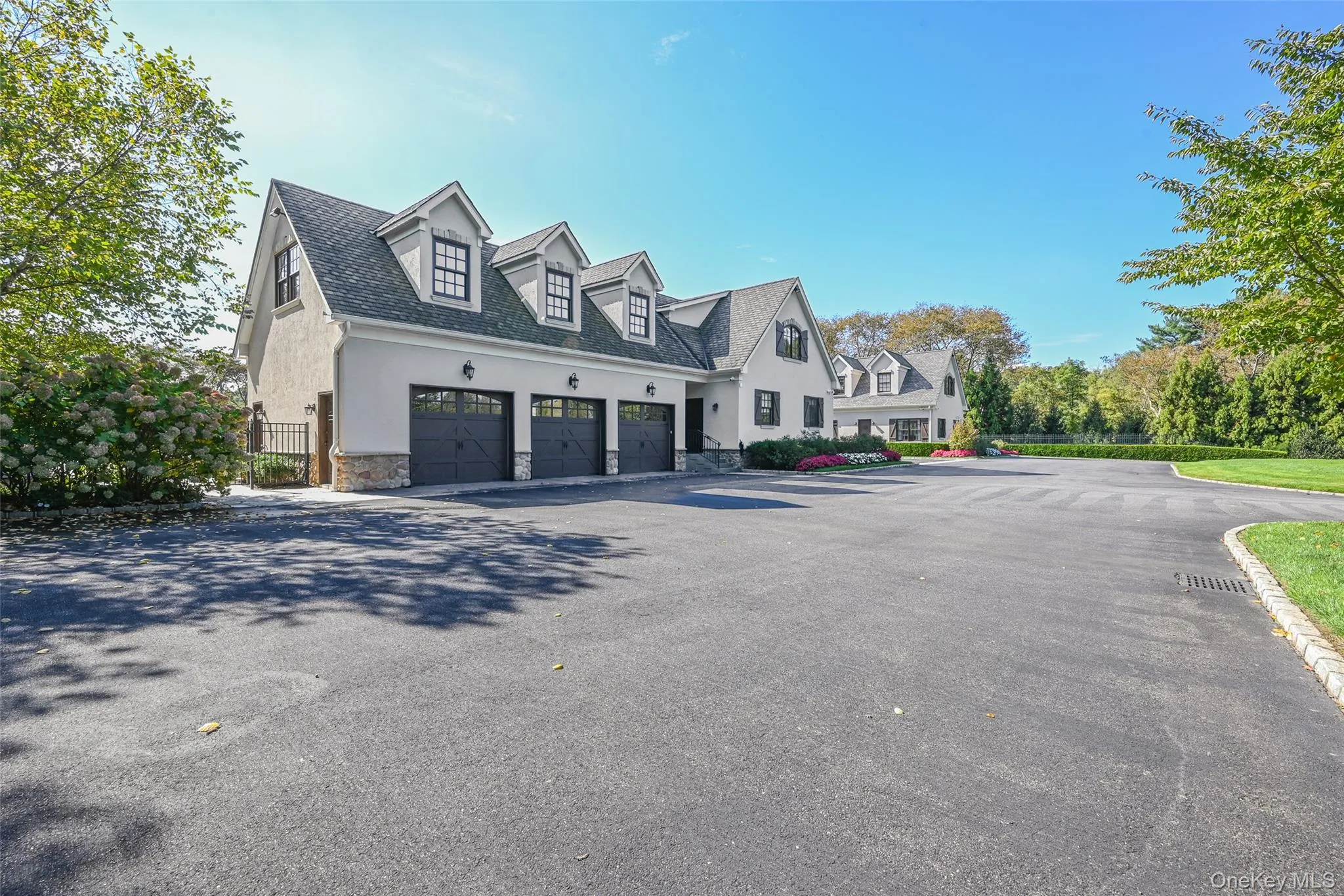 View of home's exterior featuring stucco siding, stone siding, a garage, driveway, and a shingled roof View of home's exterior featuring stucco siding, stone siding, a garage, driveway, and a shingled roof