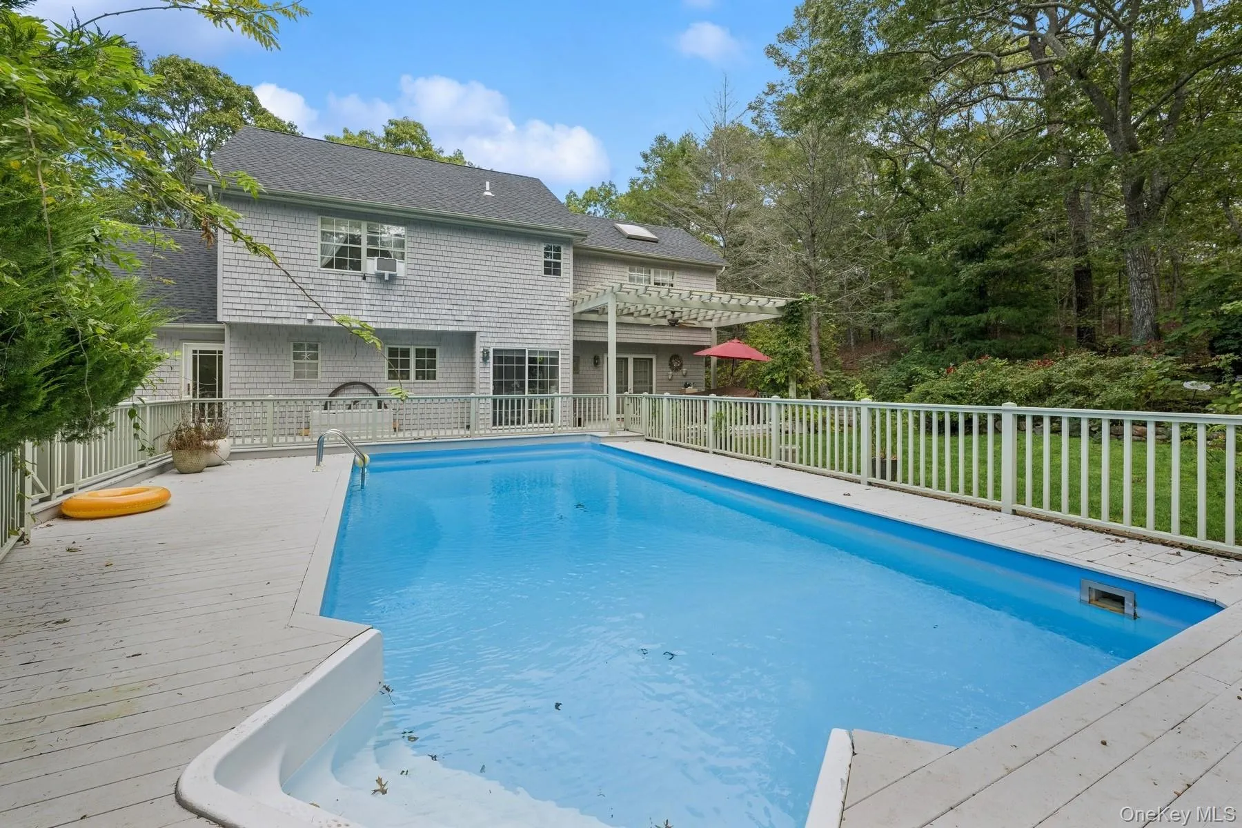 View of pool with a patio, a pergola, and a deck View of pool with a patio, a pergola, and a deck