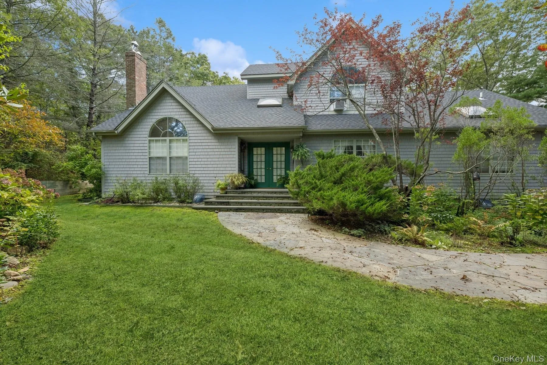 View of front of house featuring a front yard, french doors, roof with shingles, and a chimney View of front of house featuring a front yard, french doors, roof with shingles, and a chimney