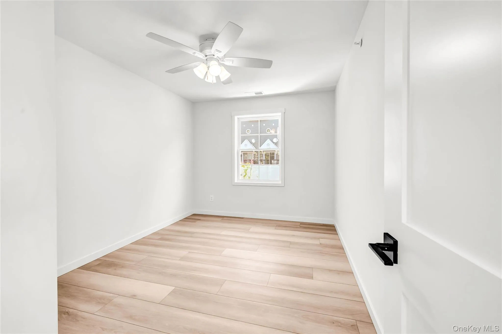 Spare room with light wood-type flooring and ceiling fan Spare room with light wood-type flooring and ceiling fan