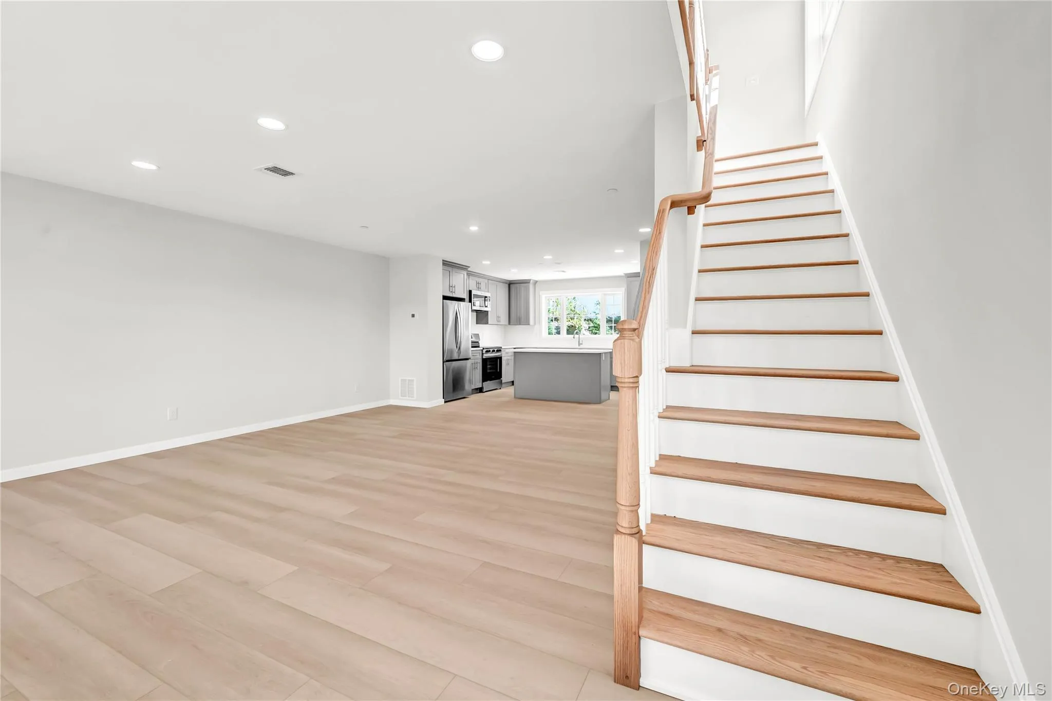 Stairway with recessed lighting and wood finished floors Stairway with recessed lighting and wood finished floors