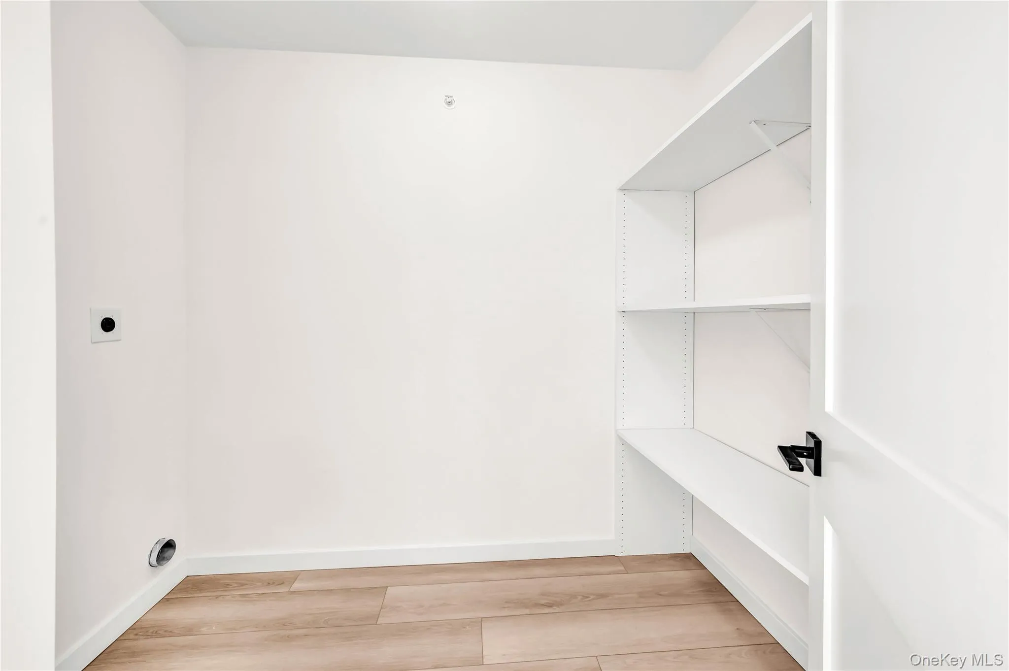 Walk in closet featuring light wood finished floors Walk in closet featuring light wood finished floors
