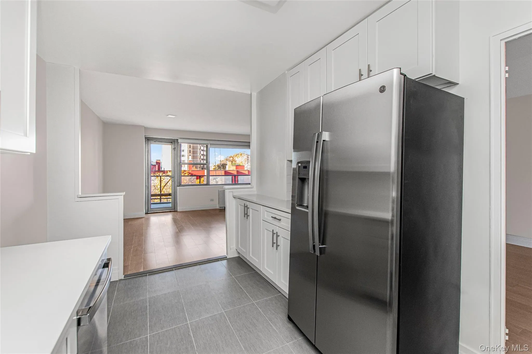 Kitchen featuring stainless steel appliances and white cabinets Kitchen featuring stainless steel appliances and white cabinets
