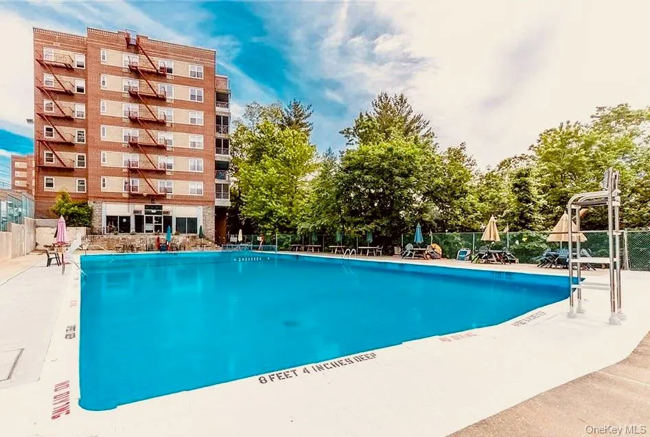 Community pool with a patio area Community pool with a patio area