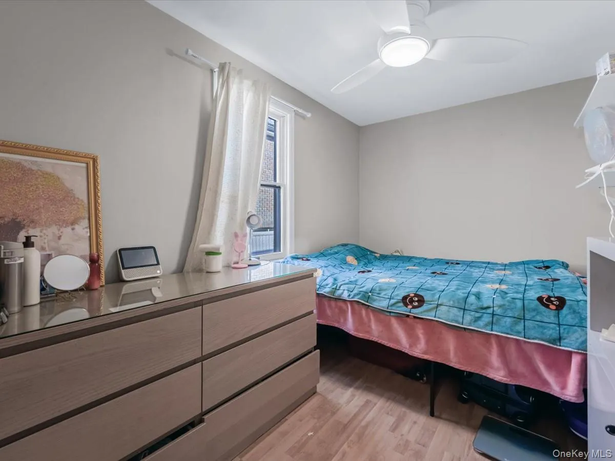 Bedroom with light wood-style flooring and ceiling fan Bedroom with light wood-style flooring and ceiling fan