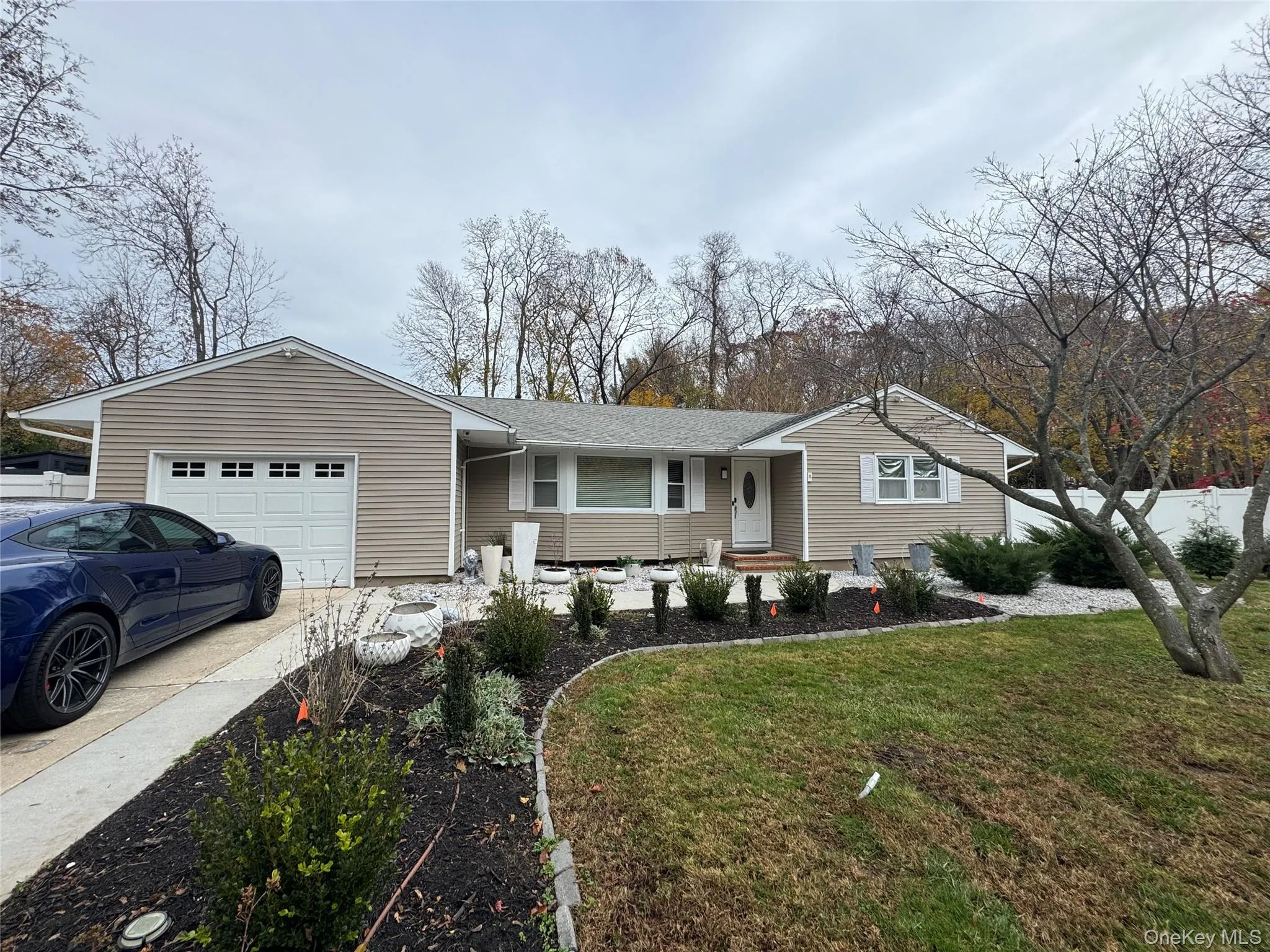 Ranch-style home featuring a front lawn, driveway, an attached garage, and a shingled roof Ranch-style home featuring a front lawn, driveway, an attached garage, and a shingled roof
