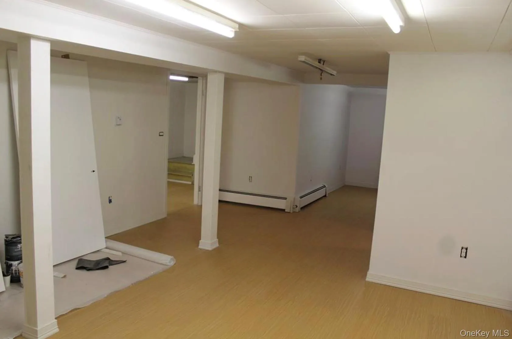 Finished basement with light wood-type flooring and baseboards Finished basement with light wood-type flooring and baseboards