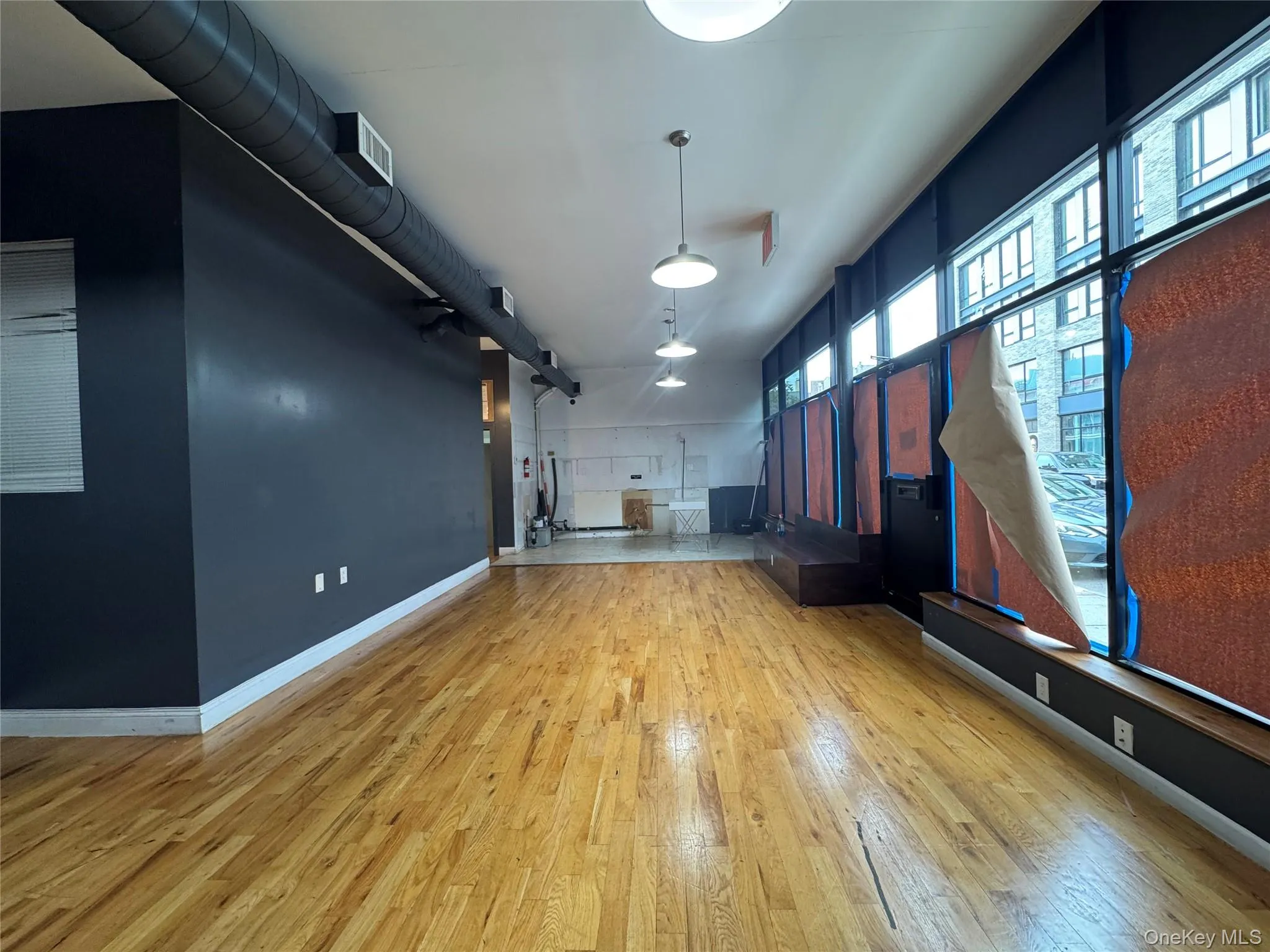Miscellaneous room featuring baseboards and light wood-style floors Miscellaneous room featuring baseboards and light wood-style floors