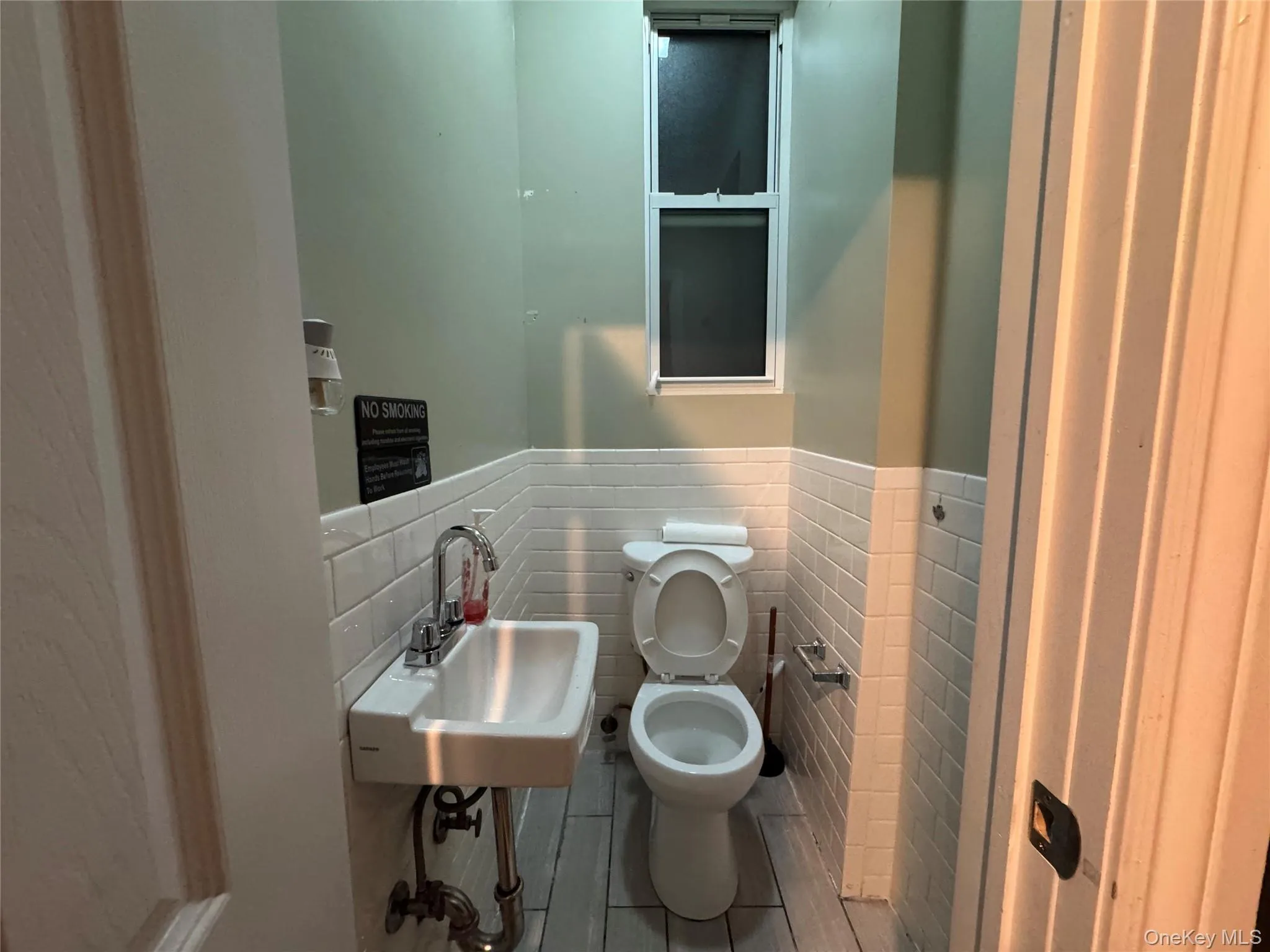 Half bath with tile walls and wainscoting Half bath with tile walls and wainscoting