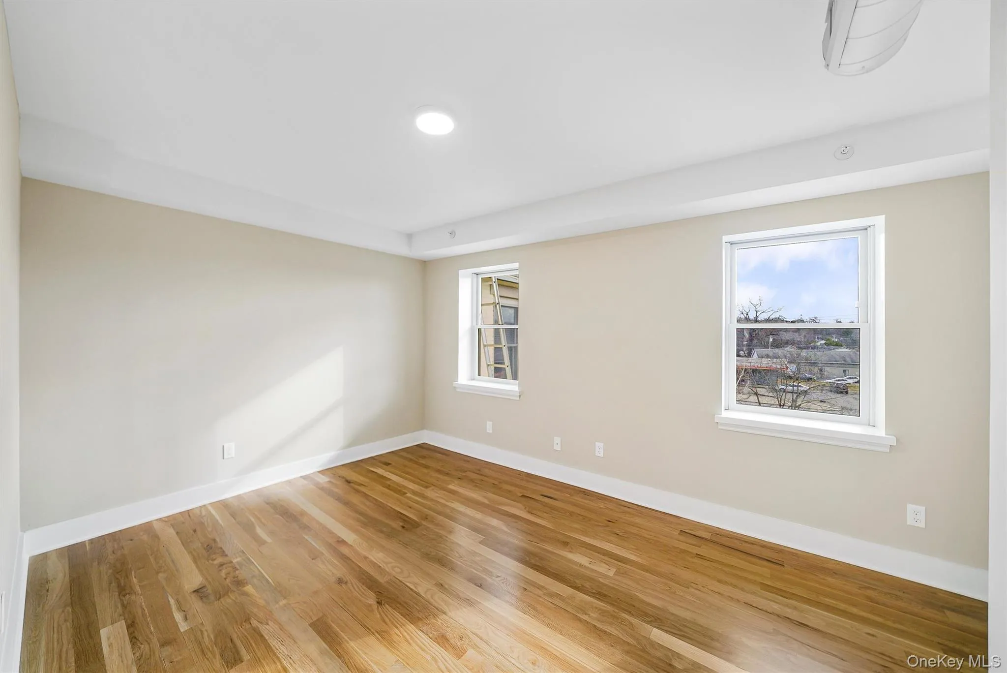 Empty room featuring wood finished floors and baseboards Empty room featuring wood finished floors and baseboards