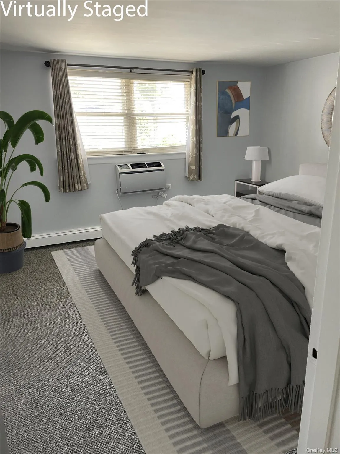 Bedroom with carpet flooring, baseboard heating, and a wall unit AC Bedroom with carpet flooring, baseboard heating, and a wall unit AC