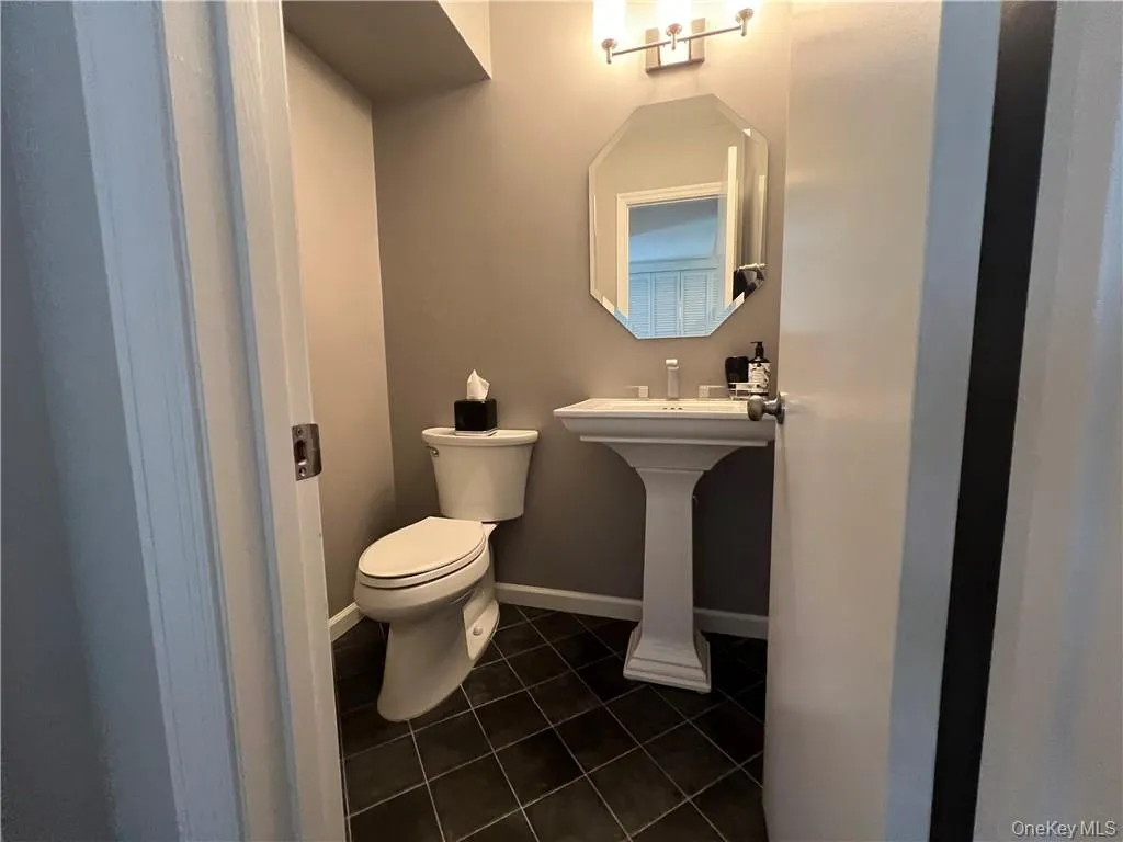 Bathroom featuring toilet and tile patterned floors Bathroom featuring toilet and tile patterned floors