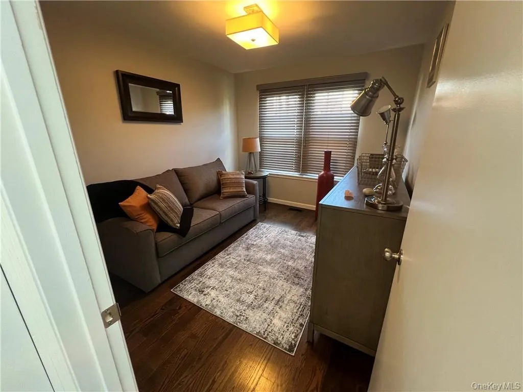 Living room with dark hardwood / wood-style flooring Living room with dark hardwood / wood-style flooring