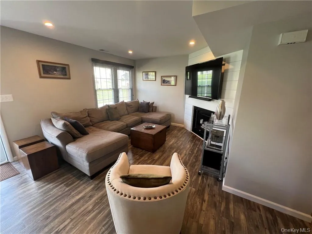 Living room featuring dark wood-type flooring Living room featuring dark wood-type flooring