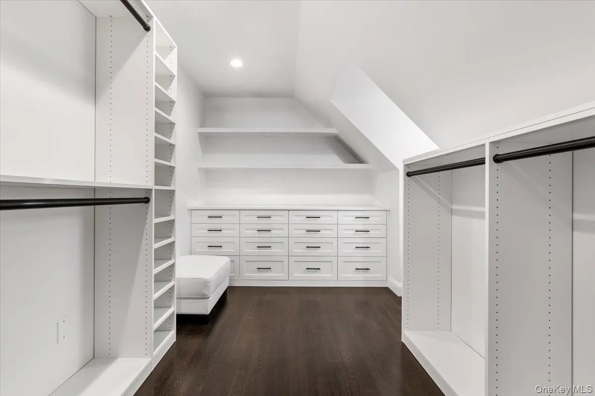 Walk in closet with dark wood finished floors Walk in closet with dark wood finished floors