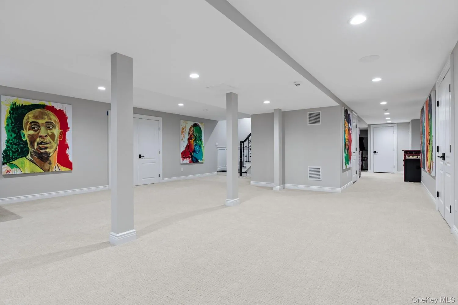 Finished below grade area featuring light carpet, recessed lighting, and stairs Finished below grade area featuring light carpet, recessed lighting, and stairs