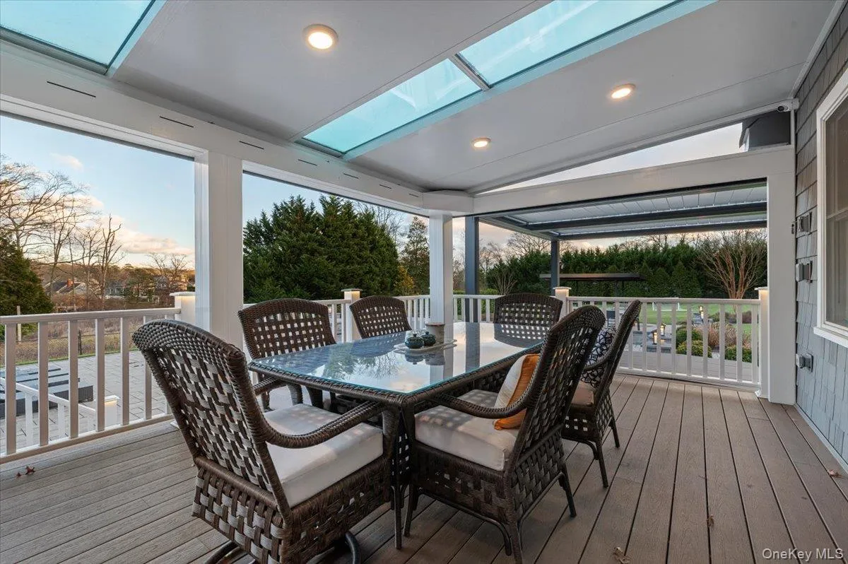 Wooden deck featuring outdoor dining area Wooden deck featuring outdoor dining area