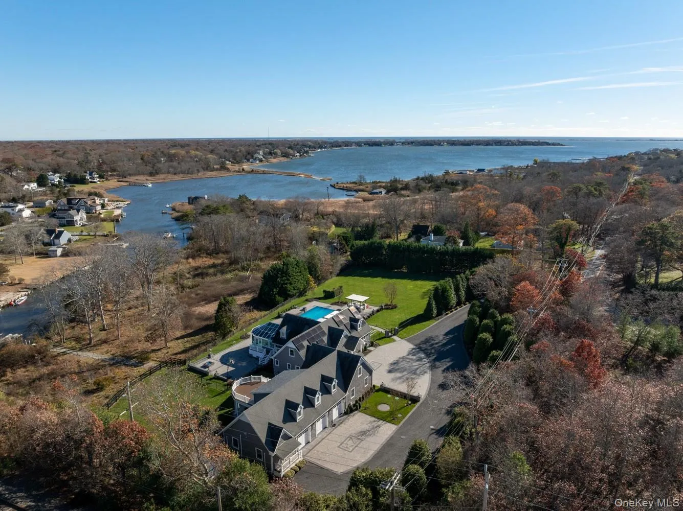 Aerial view of property and surrounding area featuring a large body of water Aerial view of property and surrounding area featuring a large body of water