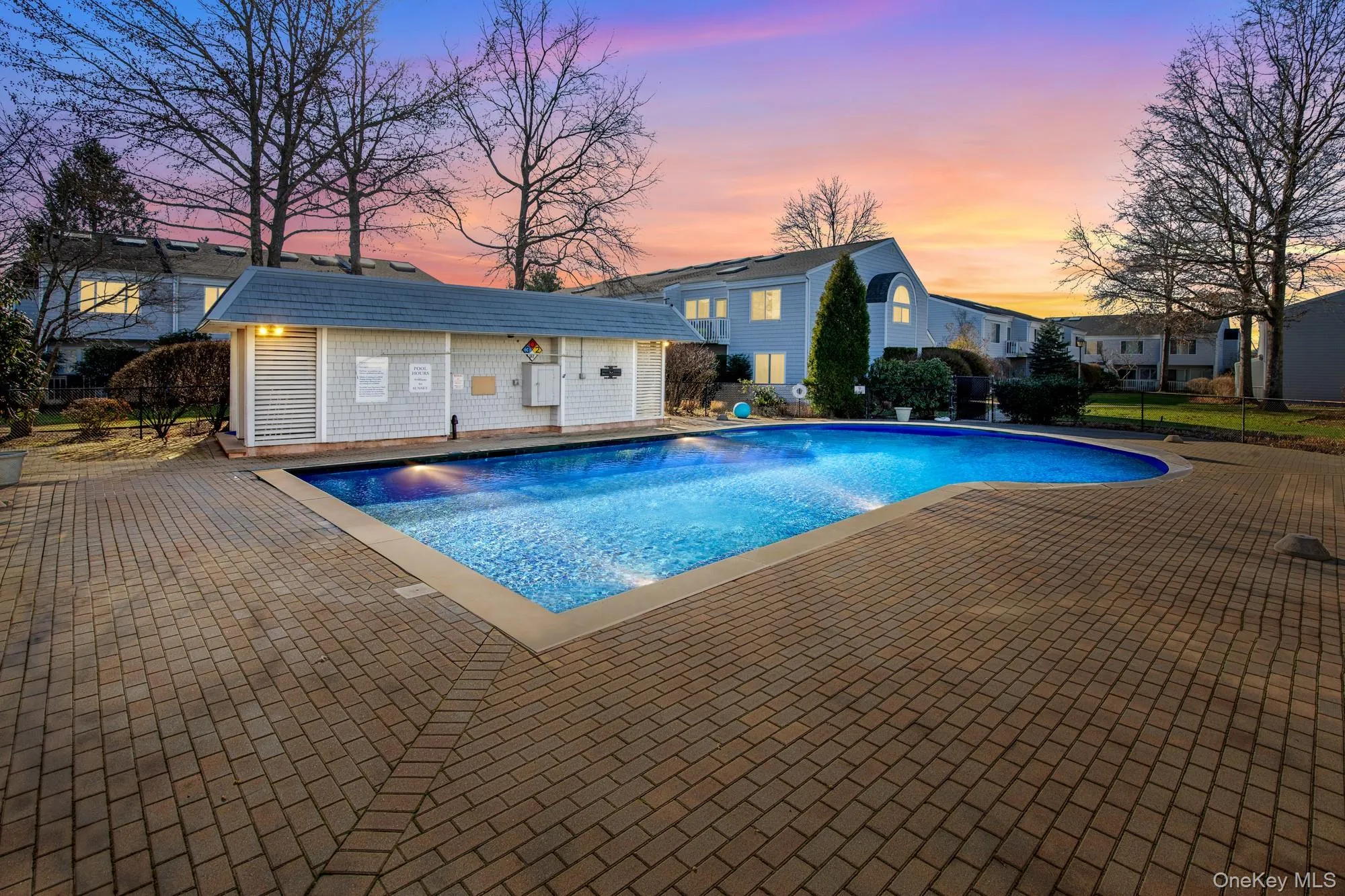 Pool at dusk with an outbuilding, a patio area, and a storage structure Pool at dusk with an outbuilding, a patio area, and a storage structure