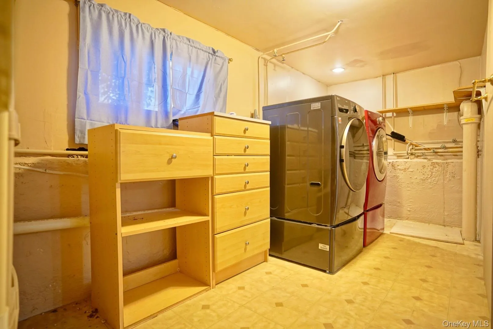 Laundry area with light flooring and washer and clothes dryer Laundry area with light flooring and washer and clothes dryer
